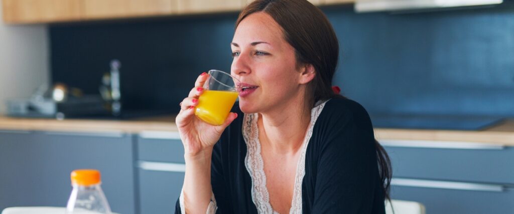 women drinking orange juice in keto